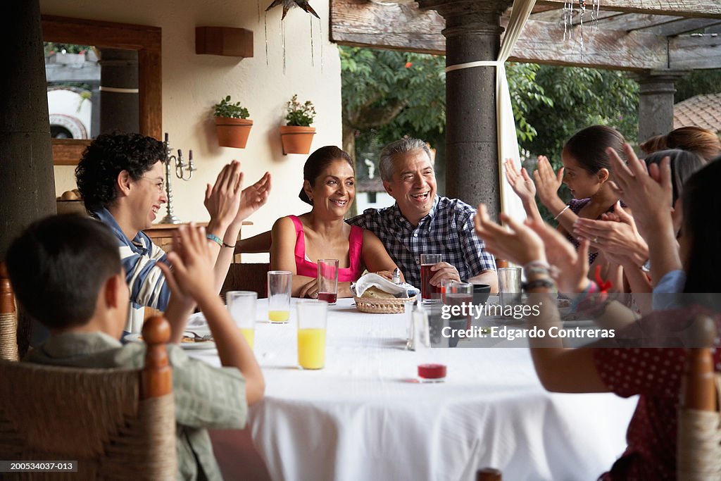 Parents and children (7-17) applauding grandparents