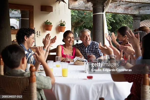 Parents and children (7-17) applauding grandparents