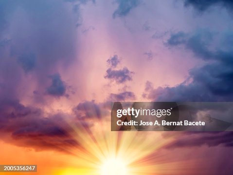 Sky with rays of sun on the horizon at sunset on a day with clouds. Sky with rays of sun on the horizon at sunset on a day with clouds.