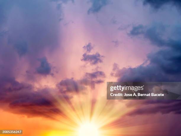 sky with rays of sun on the horizon at sunset on a day with clouds. - cielo romantico foto e immagini stock