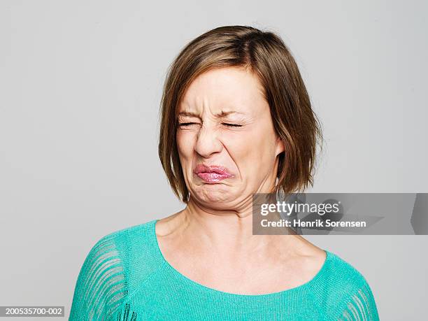 young woman pulling face - funny face stock pictures, royalty-free photos & images