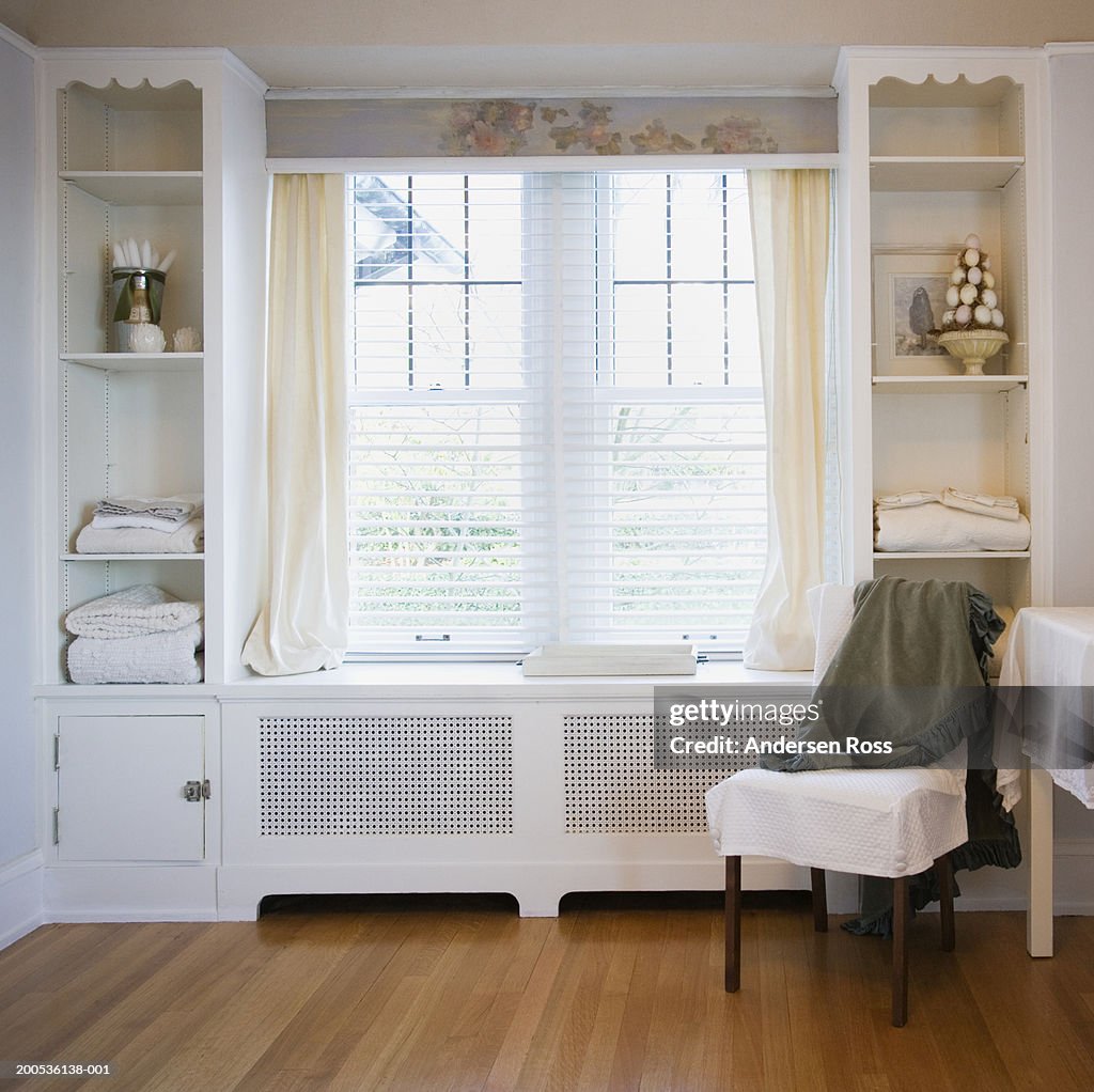 Chair beside windows in bedroom