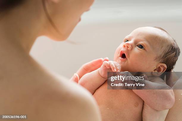 mother taking bath with baby boy (0-3 months) - mother and baby taking a bath stock pictures, royalty-free photos & images