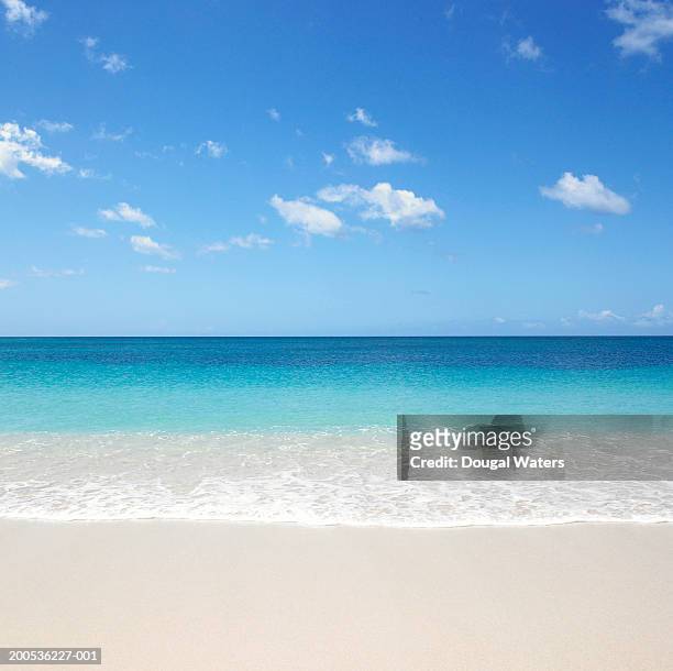 waves on beach - idyllic beach stock pictures, royalty-free photos & images