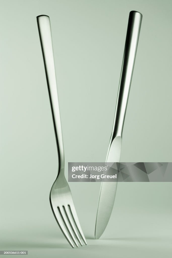 Knife and fork standing on tips, close-up