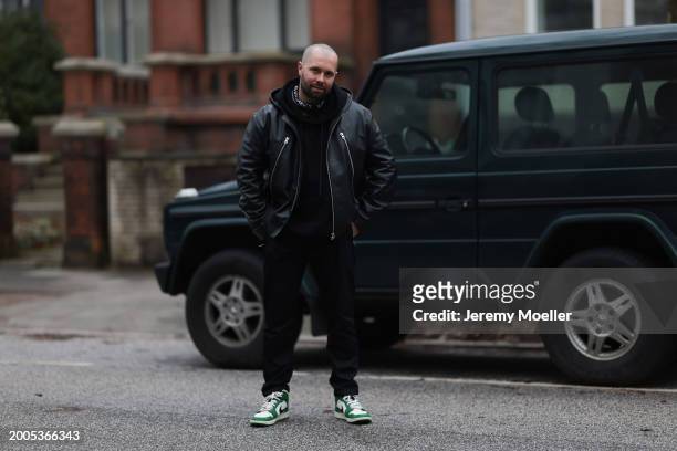 Benjamin Beyer aka David Puentez seen wearing black oversized cotton hoodie, black leather biker jacket, black denim straight leg jeans / pants and...