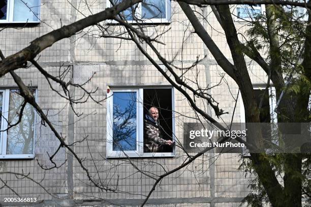 Man is seen in a window after the Russian missile attack in Lviv, Ukraine, on February 15, 2024. In the early hours of Thursday, Russian troops are...