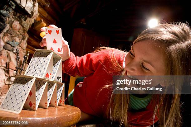 teenage girl (16-18) building house of cards, smiling - house of cards stock pictures, royalty-free photos & images