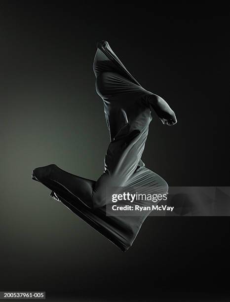 woman enveloped in sheath, jumping in midair, side view - mist enveloped stock pictures, royalty-free photos & images