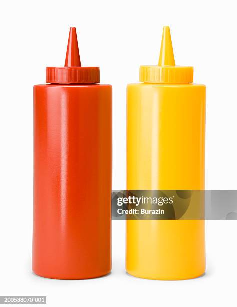 ketchup and mustard bottles, against white background, close-up - mustard stockfoto's en -beelden