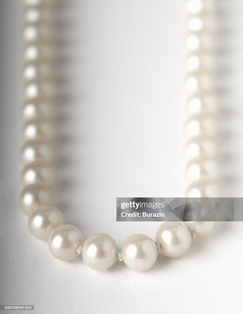 Pearl necklace, against white background, close-up