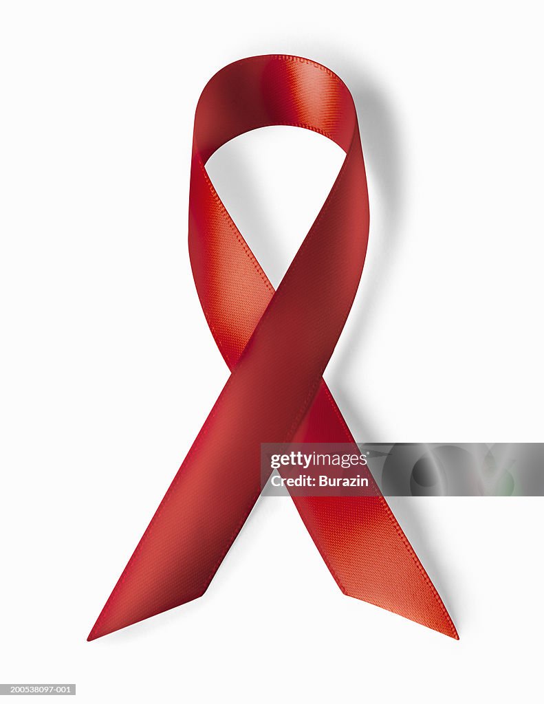 Red ribbon, against white background, close-up