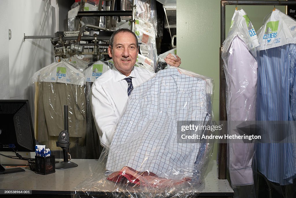 Dry Cleaners Operator Holding Shirts On Hangers Portrait High-Res Stock  Photo - Getty Images