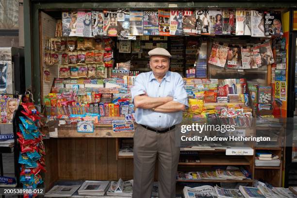 news and magazine kiosk operator in front of stand, portrait - krantenkiosk stockfoto's en -beelden