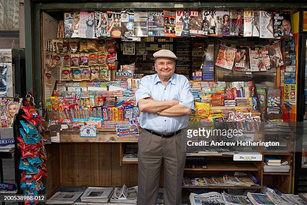 news and magazine kiosk operator in front of stand, portrait - banca de jornais imagens e fotografias de stock