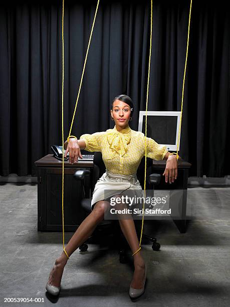 businesswoman tied up in strings - marionetta foto e immagini stock