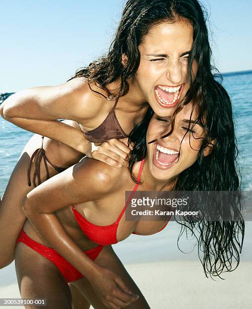 two young women messing about on beach, laughing - open day 2 bildbanksfoton och bilder