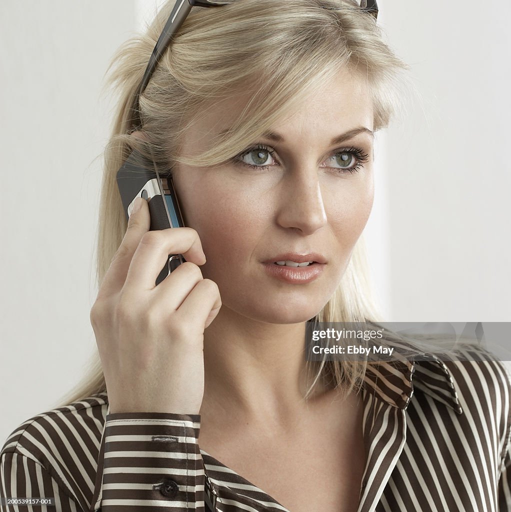 Young woman using mobile phone, close-up