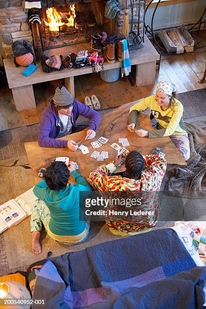 young people playing cards, elevated view - 4 people playing games stock pictures, royalty-free photos & images