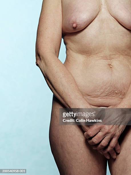 naked senior woman, mid section, front view - pezón fotografías e imágenes de stock