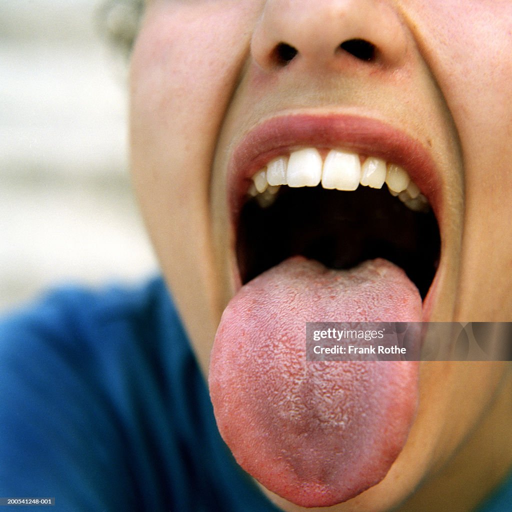 Woman sticking out tongue, close-up