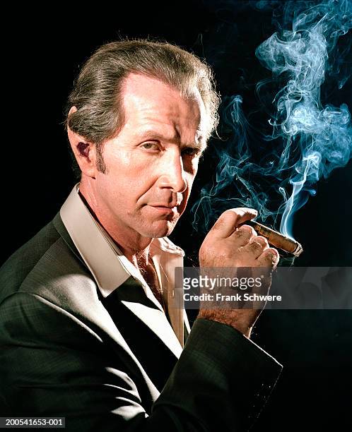 mature businessman with hairy hands and enlarged ears, portrait - cigar stock-fotos und bilder