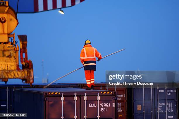belgium, zeebrugge, dock worker standing on container, rear view - dock worker stock pictures, royalty-free photos & images