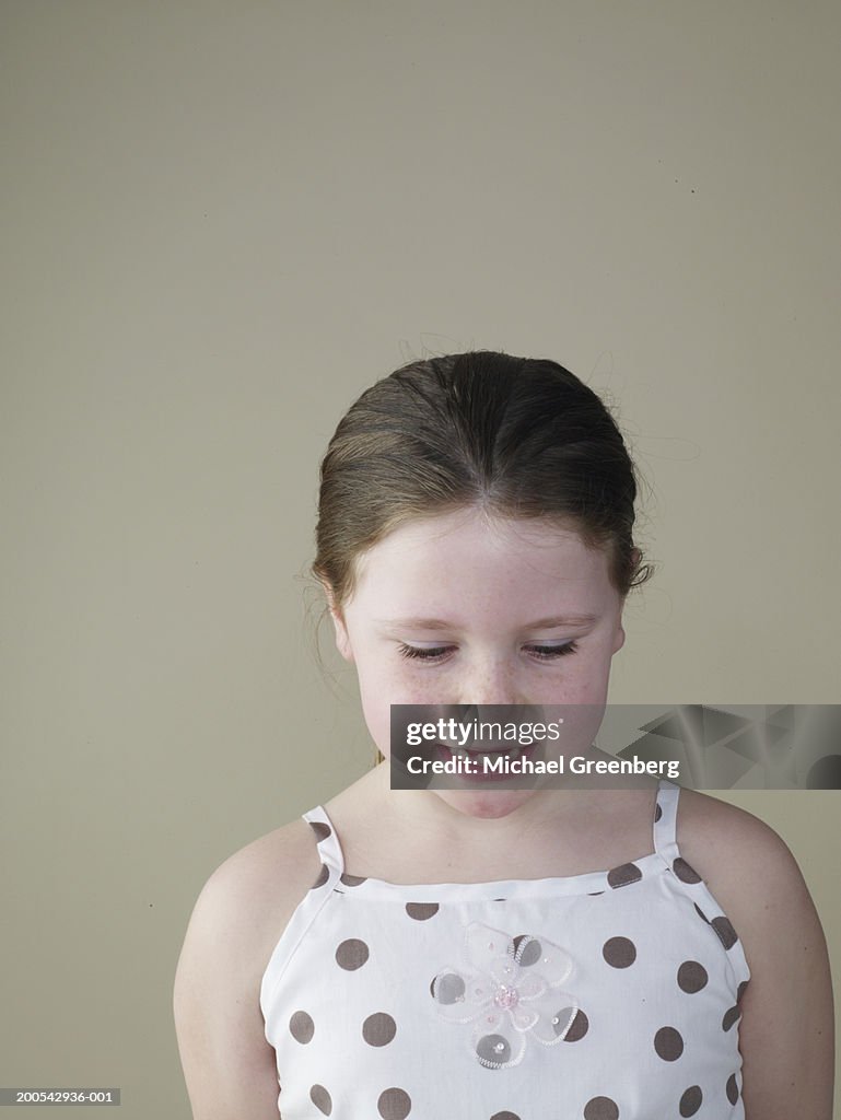 Girl (7-9) looking downwards