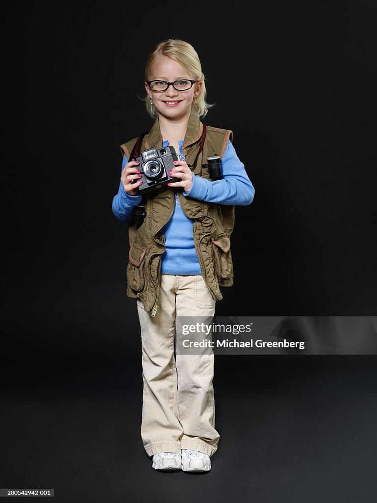 Girl (7-9) dressed as photographer, portrait