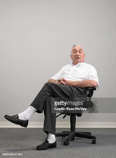 senior businessman sitting on office chair, portrait - man office chair stock pictures, royalty-free photos & images