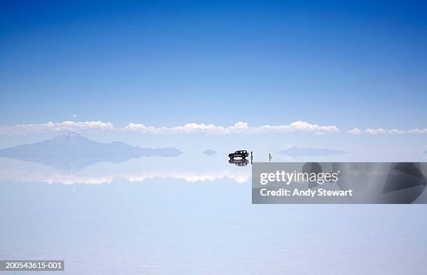 vehicle and people on salt flat - salt flats stock pictures, royalty-free photos & images