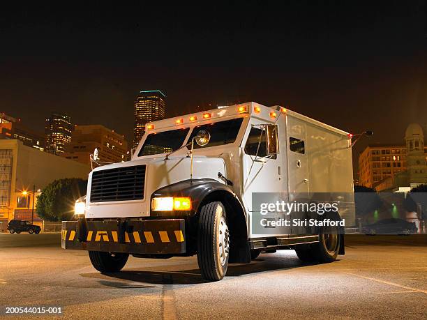 armored car illuminated by artificial light - panzerfahrzeug stock-fotos und bilder