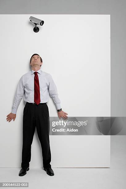 businessman hiding from security camera, studio shot - shirt and tie stock pictures, royalty-free photos & images