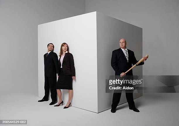 two business people hiding from colleague with baseball bat - basebollträ bildbanksfoton och bilder
