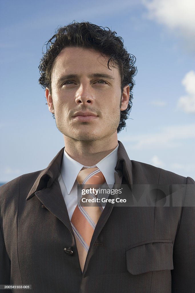 Businessman standing, close-up, low angle view