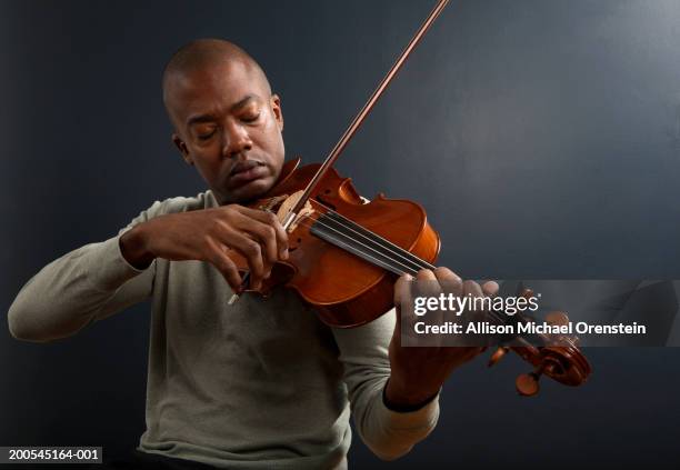 bald man playing violin, waist up - violino foto e immagini stock