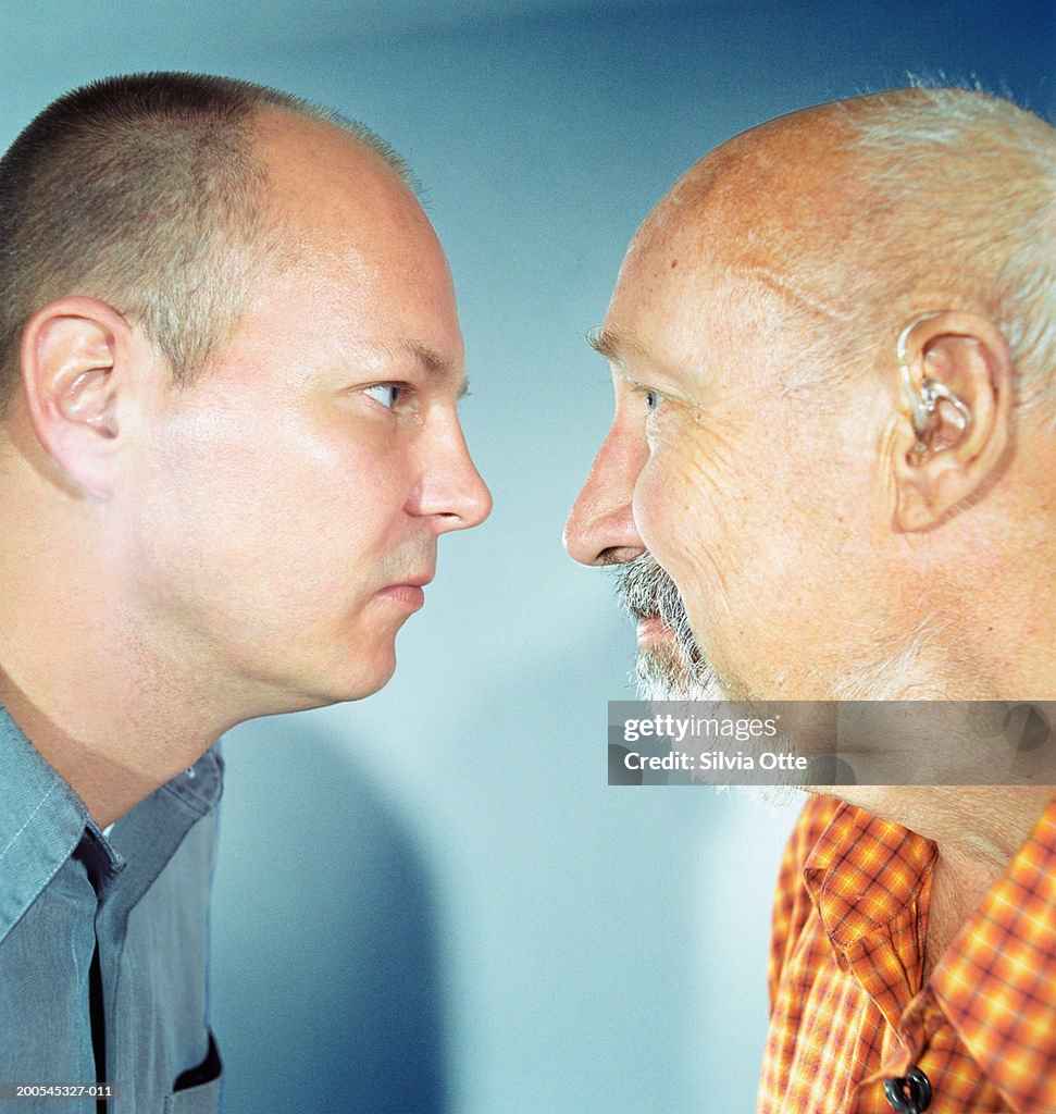 "Father and son face to face, close-up"