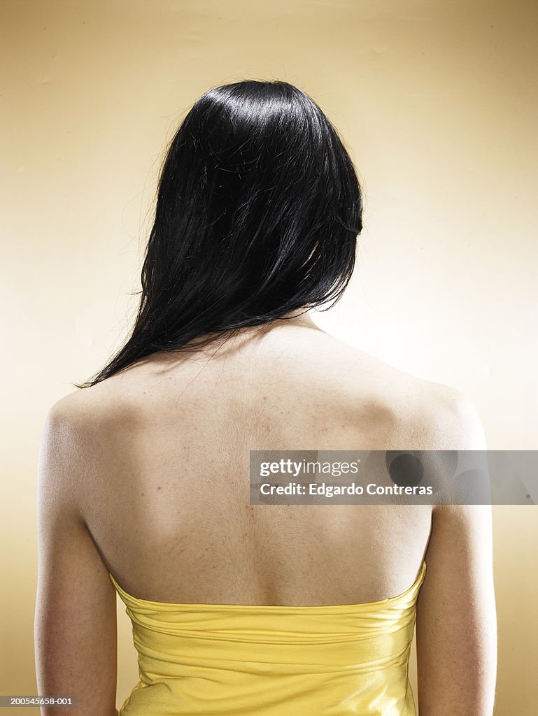 Young woman wearing strapless top, rear view