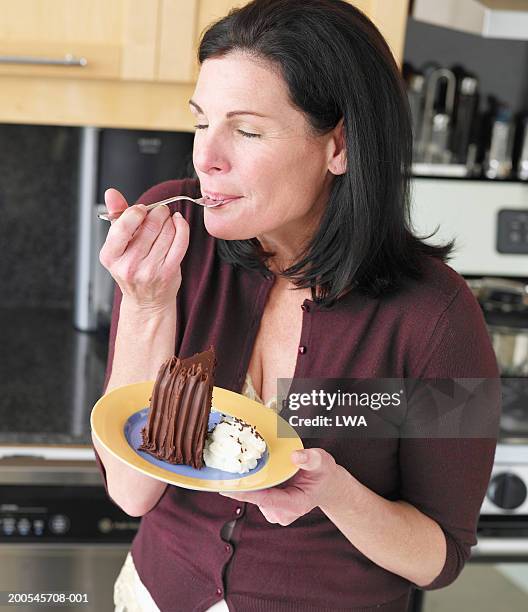 woman eating cake, eyes closed, close-up - eine seniorin allein stock-fotos und bilder