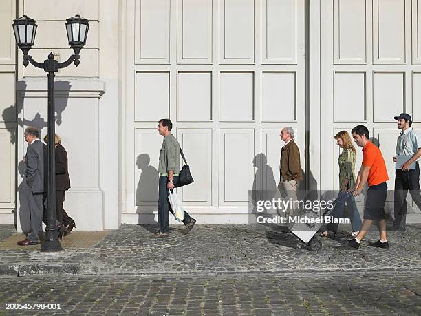 People Walking In Street Side View High-Res Stock Photo - Getty Images
