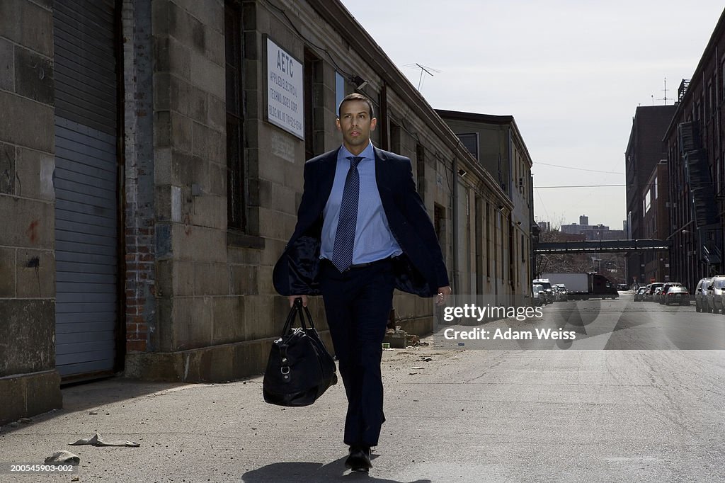 Businessman walking in industrial area