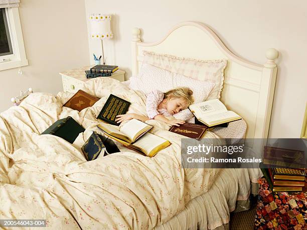 girl (4-6) sleeping in bed surrounded with books - surrounding stock pictures, royalty-free photos & images