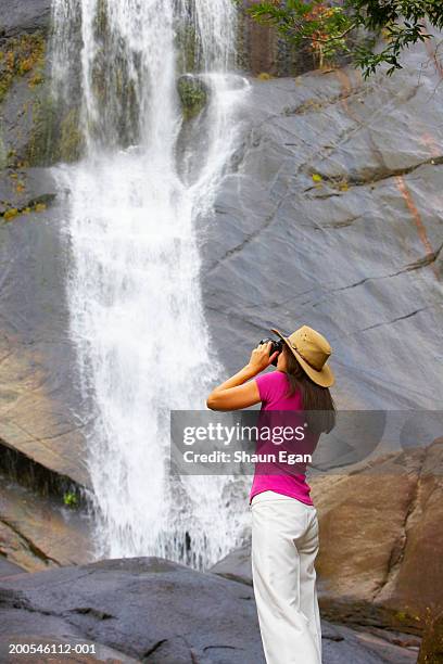 malaysia, pulau langkawi, telaga tujuh, woman photographing watefall - telaga tujuh waterfall ストックフォトと画像