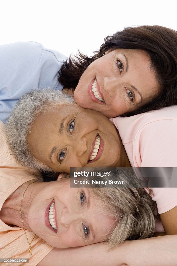 Senior and mature women resting heads together, smiling, portrait