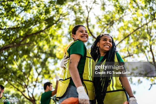 recyclers women celebration after cleaning the public park - volunteer stock pictures, royalty-free photos & images