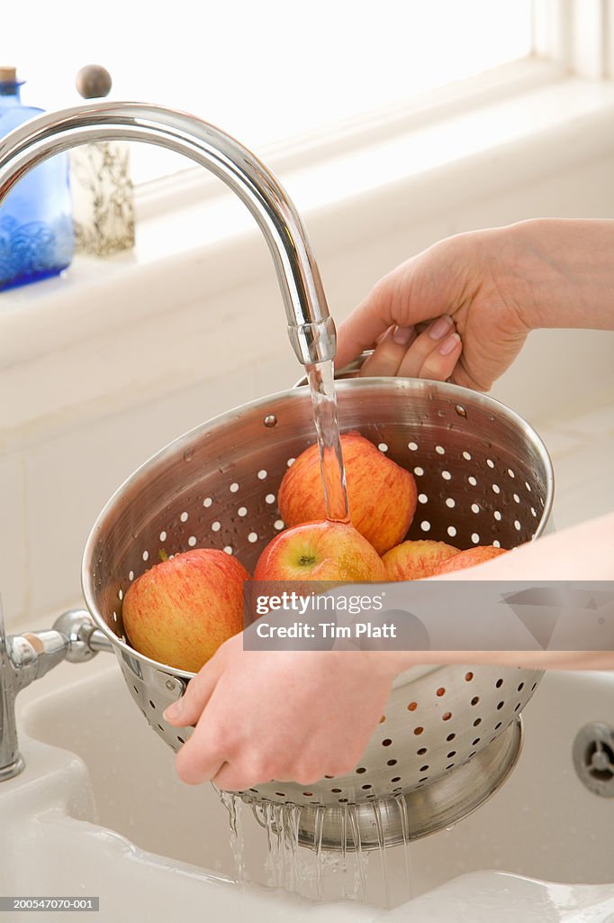 Woman Washing Apples In Kitchen Sink Closeup Elevated View High-Res ...