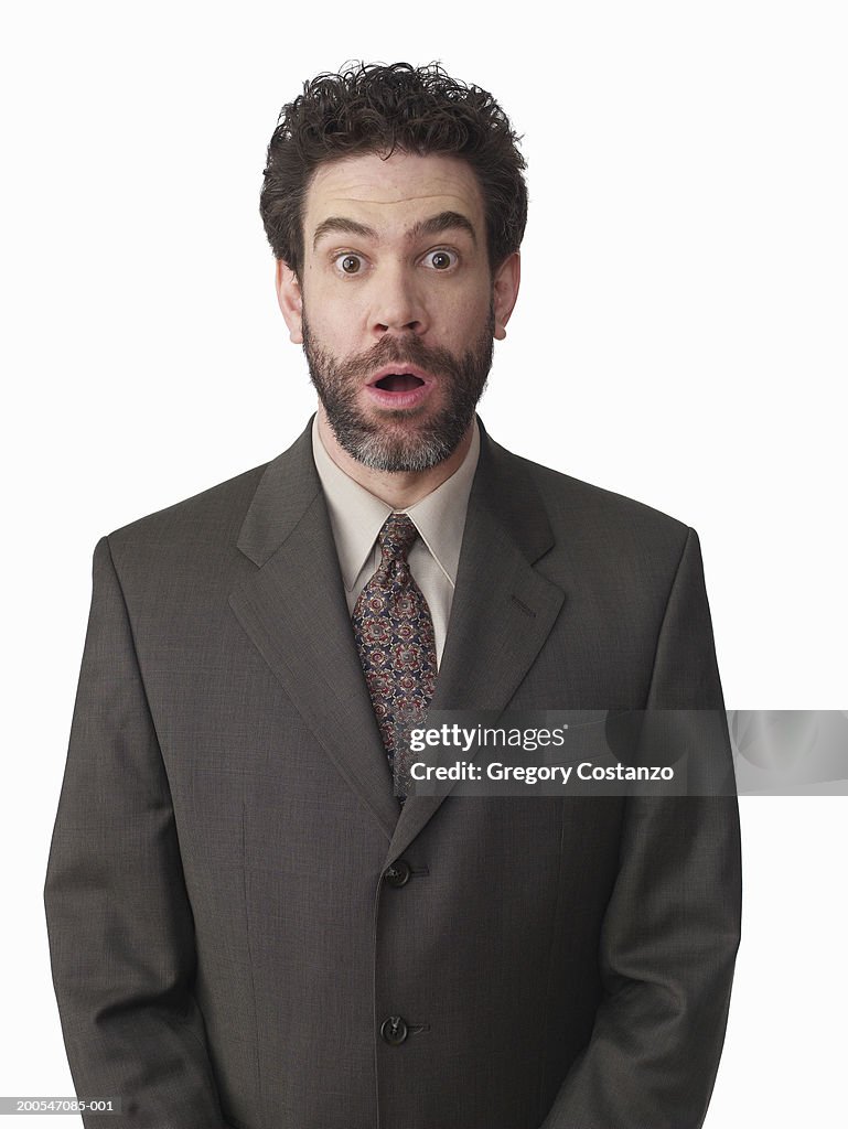 Surprised businessman on white background, portrait