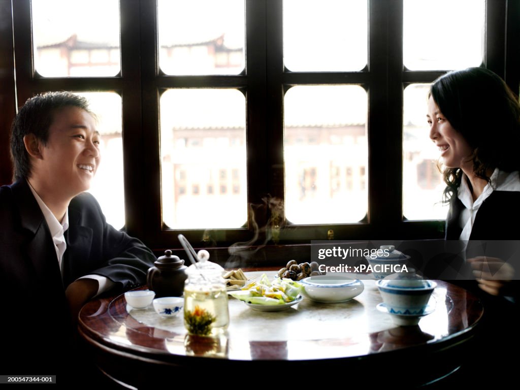 Chinese businessman and woman in traditional tea house