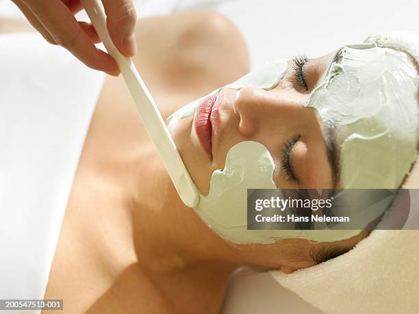 woman having facial, head and shoulders - schönheitssalon stock-fotos und bilder