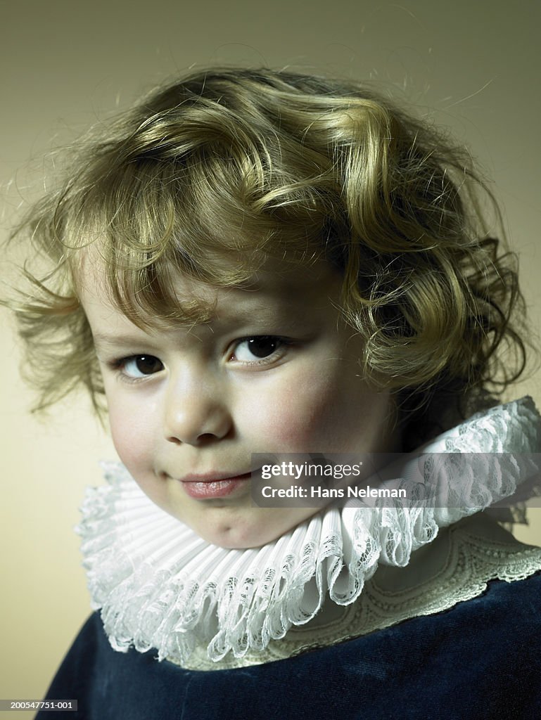 Boy (2-3) in prince costume with golden curly hair, portrait